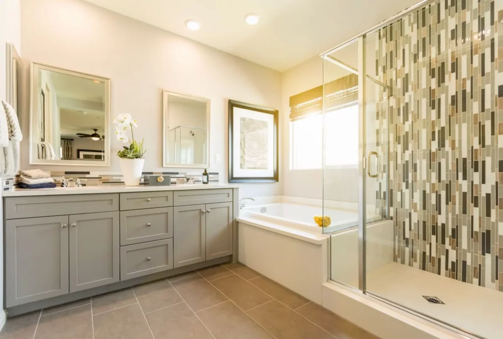 The cabinetry and tile work in this bathroom remodeling project reflect the homeowner’s taste and combine traditional with contemporary styles.