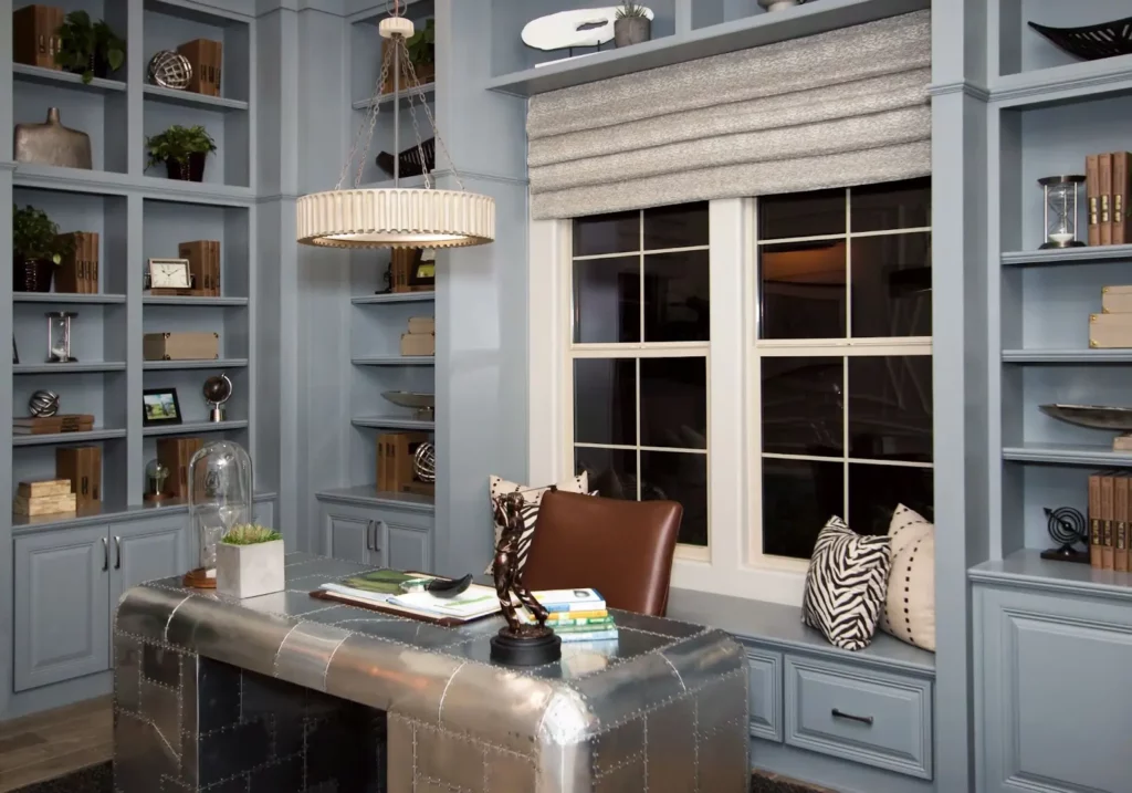 Built-in custom cabinetry surrounds a spacious home office window. schedule a consultation and experience the transformative power of custom cabinetry!